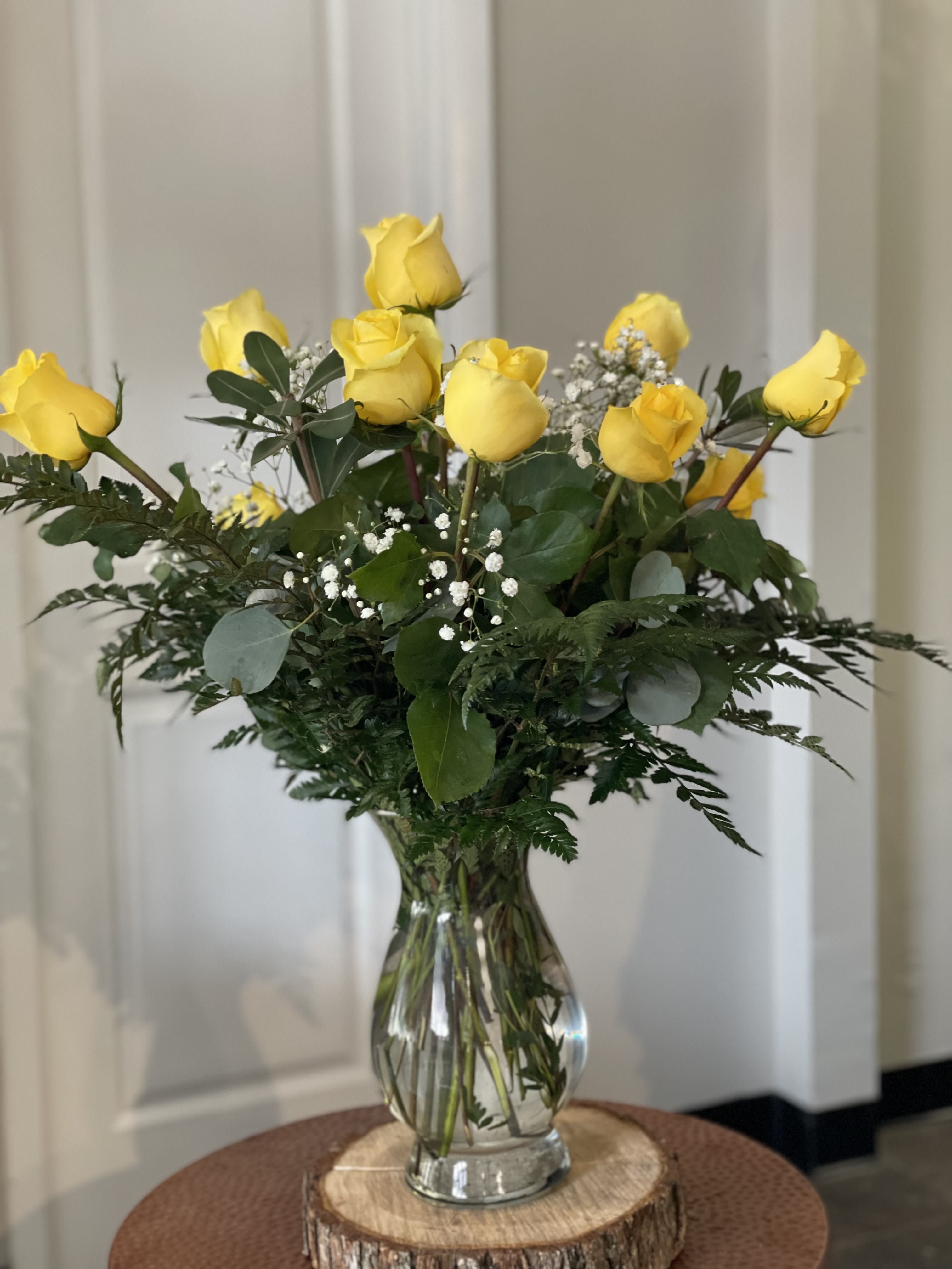Yellow roses arranged in a clear glass vase