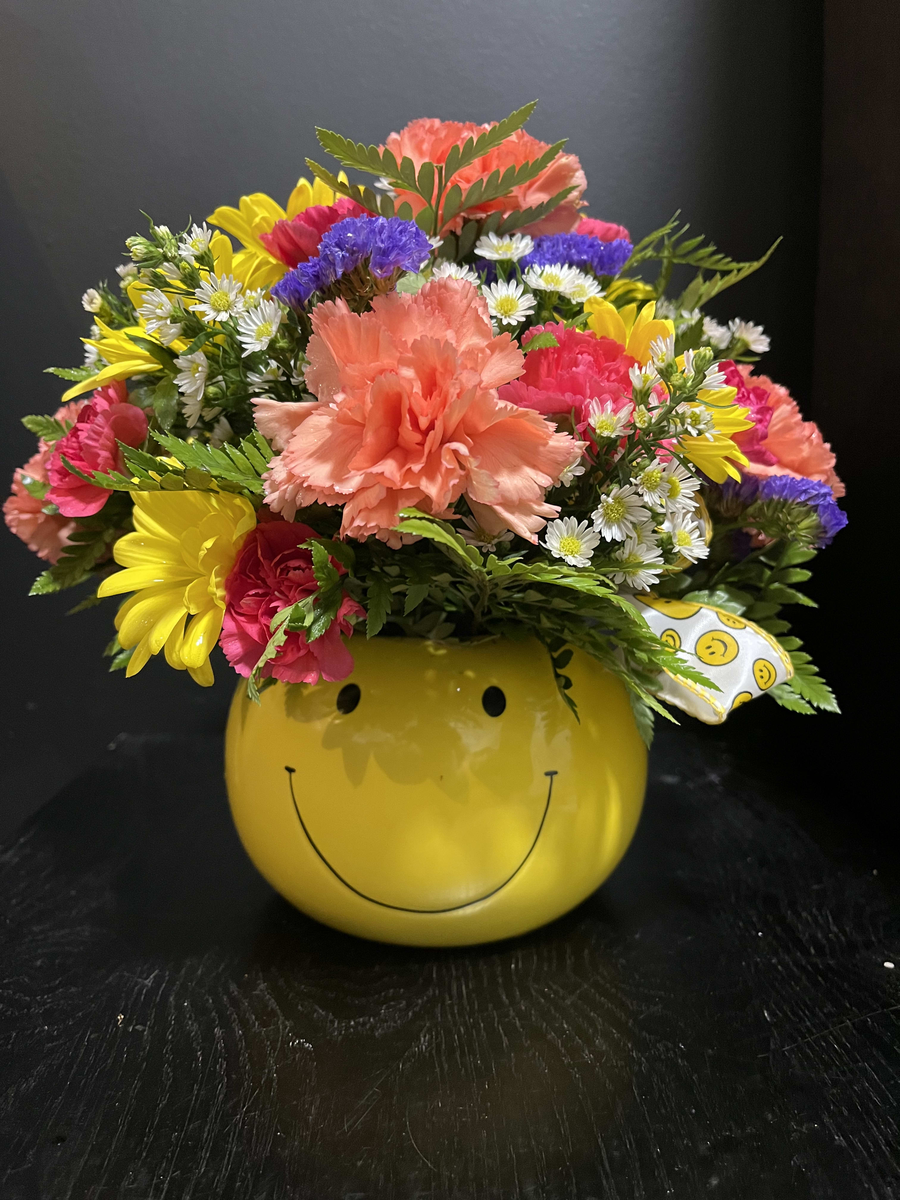 Colorful mixed bouquet in a yellow smiley-face container