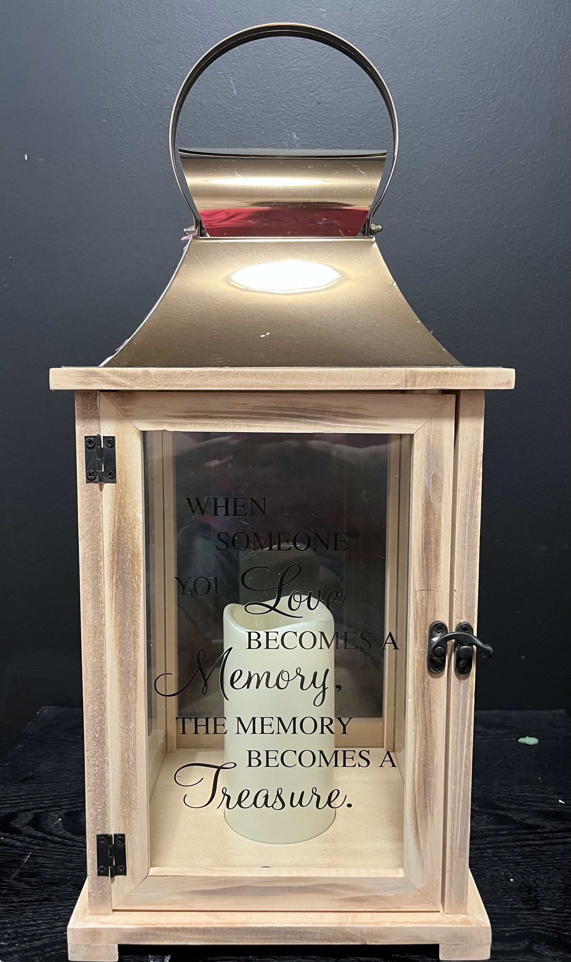 Wooden memorial lantern with a candle and sympathy quote