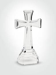 Clear glass cross-shaped candle holder on a white background
