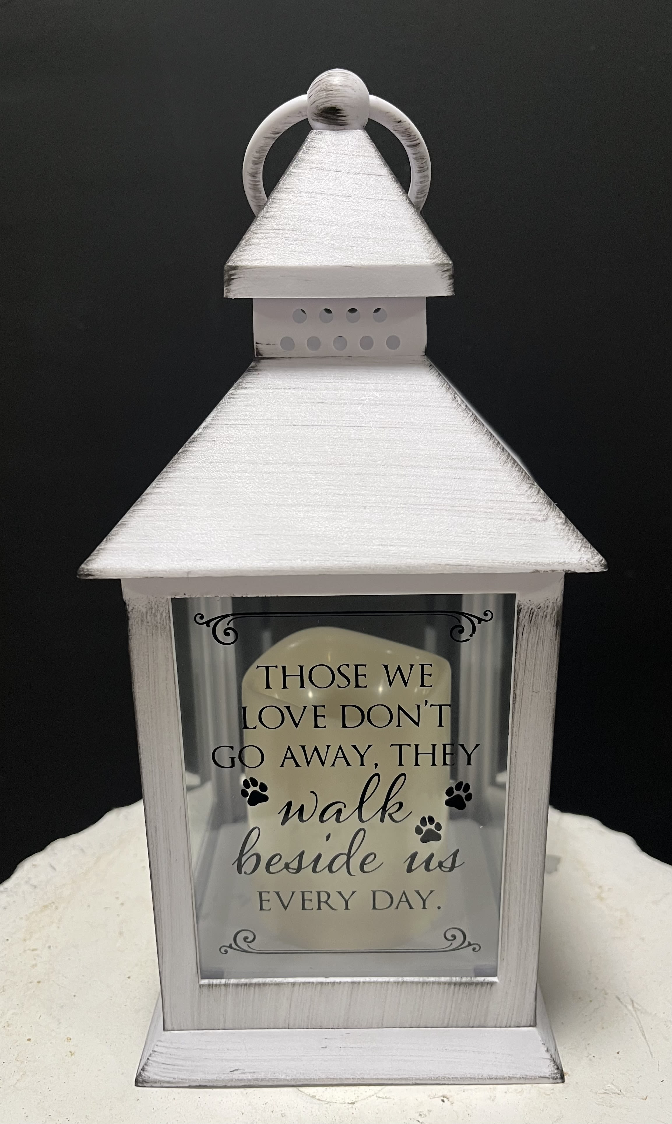 White memorial lantern with a sympathy quote and paw prints