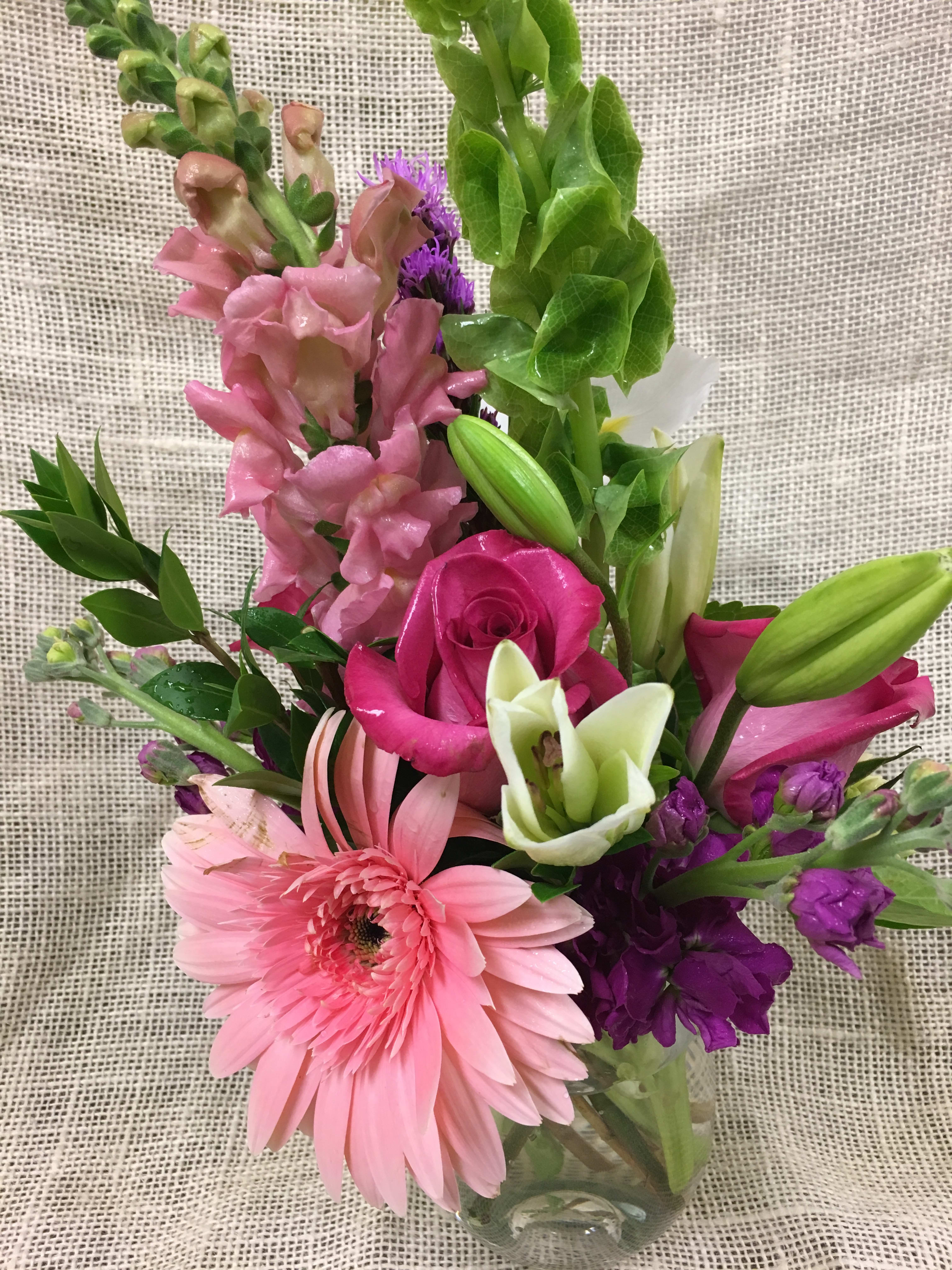 A little Pink me Up - Varied Pink Blossoms - One of our best loved arrangements, these soft and subtle shades of pink are perfect to say "Thank You," "Happy Birthday," "Get Well," or "I Love You". Gorgeous Seasonal Pinks may include Gerbera Daisies, Lilies, and Roses, accented by lovely greens and whites.   We custom create each piece based on availability and seasonality of flowers, and want each arrangement to be one of a kind.  Rest assured- your arrangement will have the look and feel you've chosen.  Please feel free to leave comments for the designer you would like us to take into account in designing your unique arrangement.
