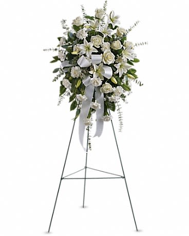 White funeral spray on a standing easel with ribbon