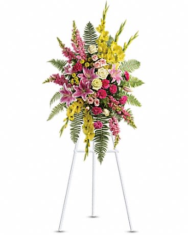 Tall floral spray on a stand with pink, yellow, and white flowers