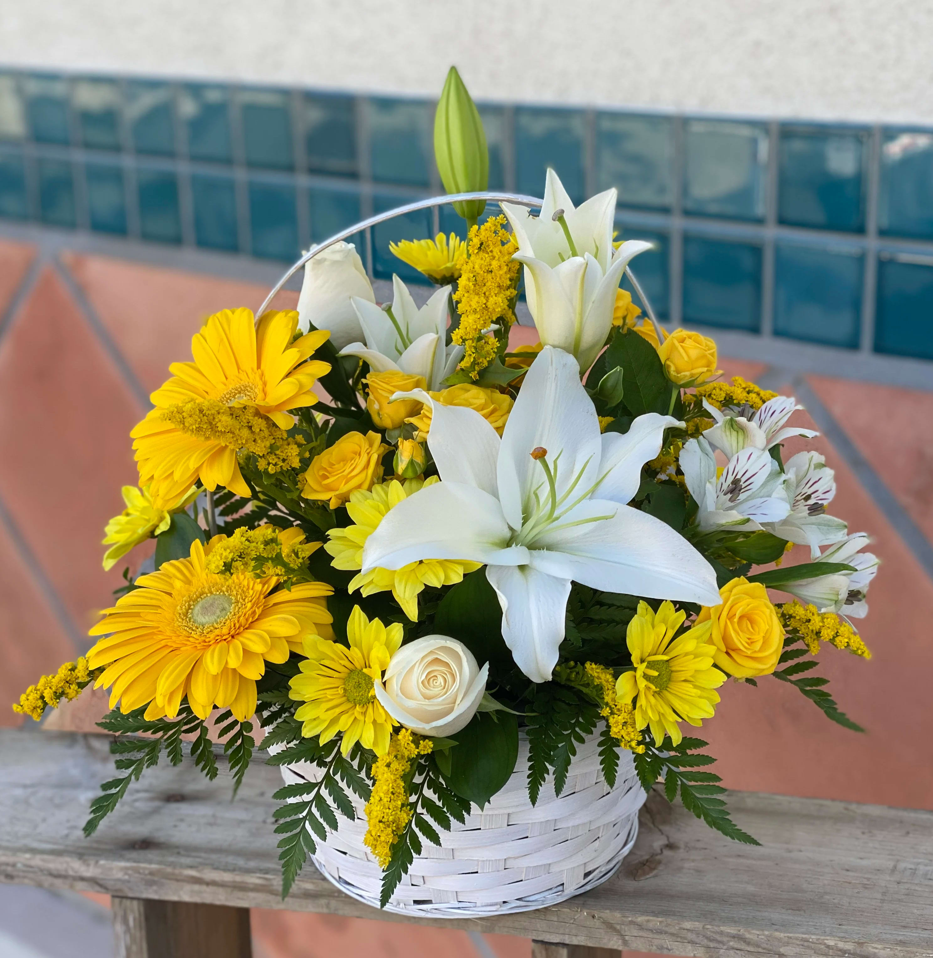 Basket Full of Wishes - Wishes do come true by the basketful actually. This delightful arrangement is so full of sunny blossoms it even includes a pretty butterfly who obviously feels right at home basking in the warmth.