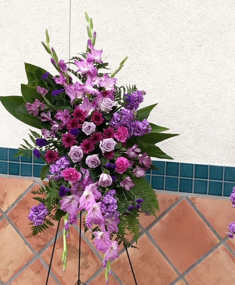 Tall purple floral standing spray on an easel