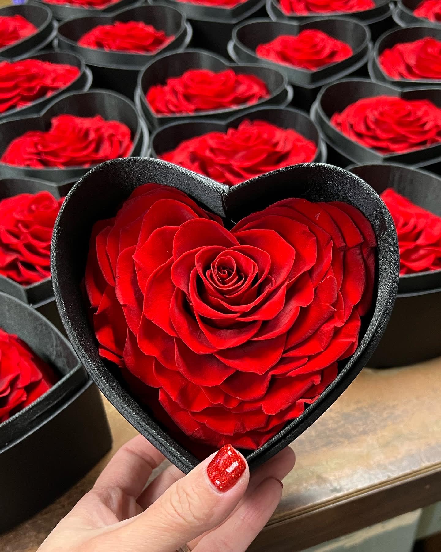 Red rose in a black heart-shaped box