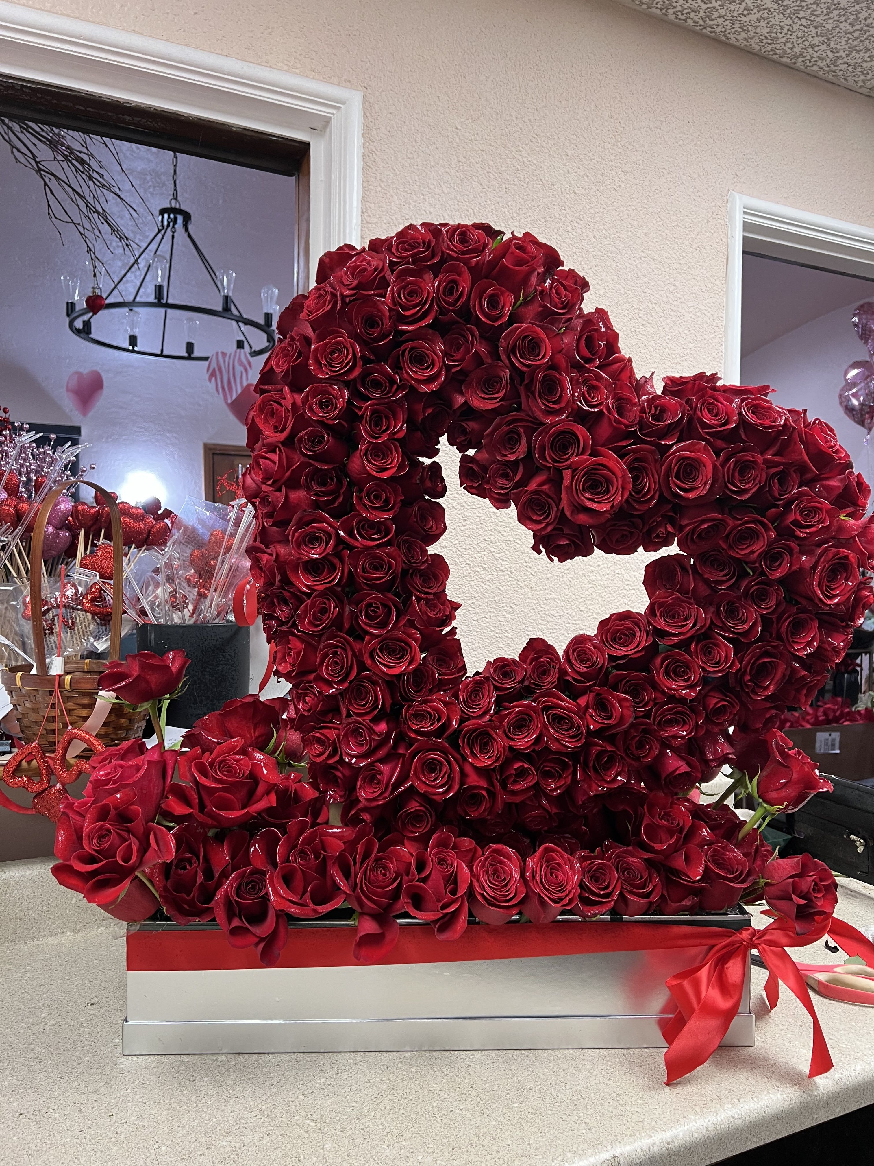 You open up my heart - Large open heart on top of a bed of roses. A beautiful and large arrangement with all red roses.