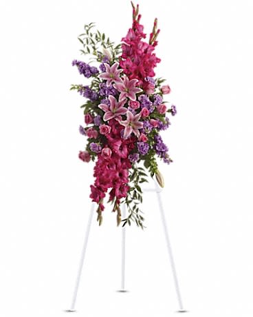 Tall floral spray with pink lilies and purple flowers on a stand