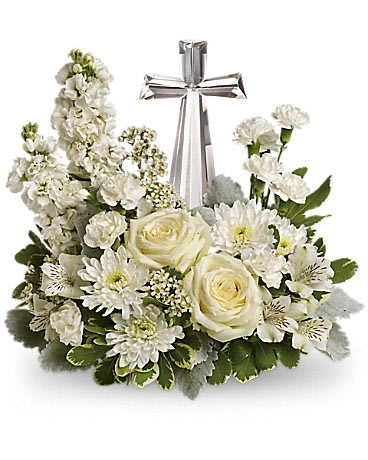 White floral arrangement with a silver cross centerpiece