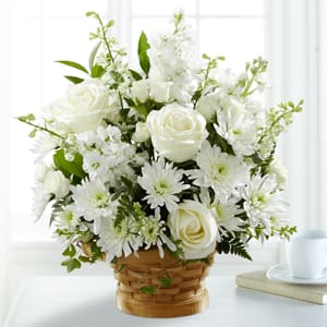 White roses and daisies in a woven basket