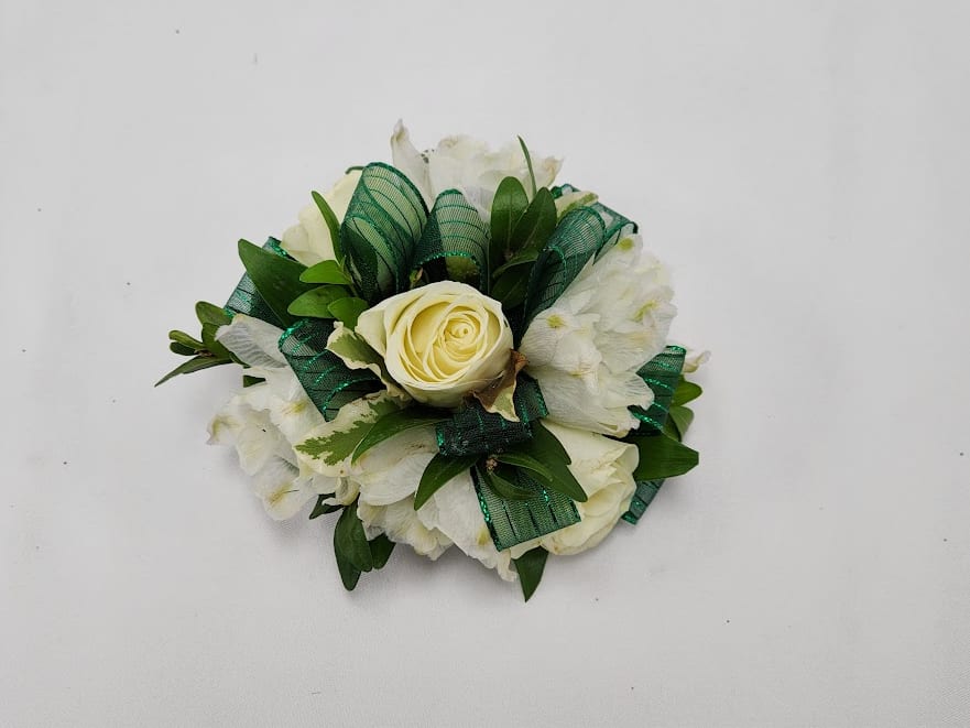 Green Envy Wristlet - Select this white spray rose wristlet corsage with white bella donna and emerald green ribbon. This wristlet corsage will come on a simple silver elastic band. Exact flowers may vary. 