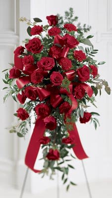 Sweet Thoughts Standing Spray - Red carnations and red roses are elegantly arranged and accented with a ribbon in this beautiful spray. Arrangement is delivered on an easel and is appropriate to send to a funeral home or service. 