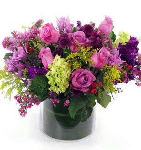 Moonlight Medley - Bursting with rich color and charm, the Moonlight Medley Arrangement is a stunning blend of deep purples, soft pinks, and vibrant greens. Featuring luxurious roses, striking chrysanthemums, and fresh hydrangeas, along with pops of yellow-green accents, this bouquet radiates a sense of joy and elegance. The addition of delicate greenery and berry-like details adds depth and texture, creating a visually captivating arrangement. Perfect for expressing love, appreciation, or adding a touch of beauty to any space, this bouquet is elegantly presented in a modern glass vase for a sleek, contemporary finish.