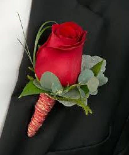 Single red rose boutonniere with greenery and a wrapped stem