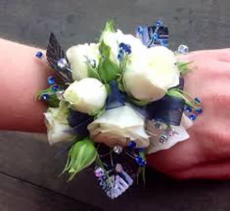 White rose wrist corsage with blue accents and ribbon