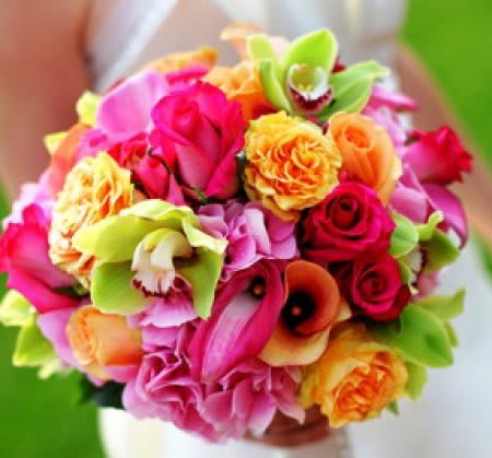 Bright mixed bouquet of roses and orchids in pink, orange, and green