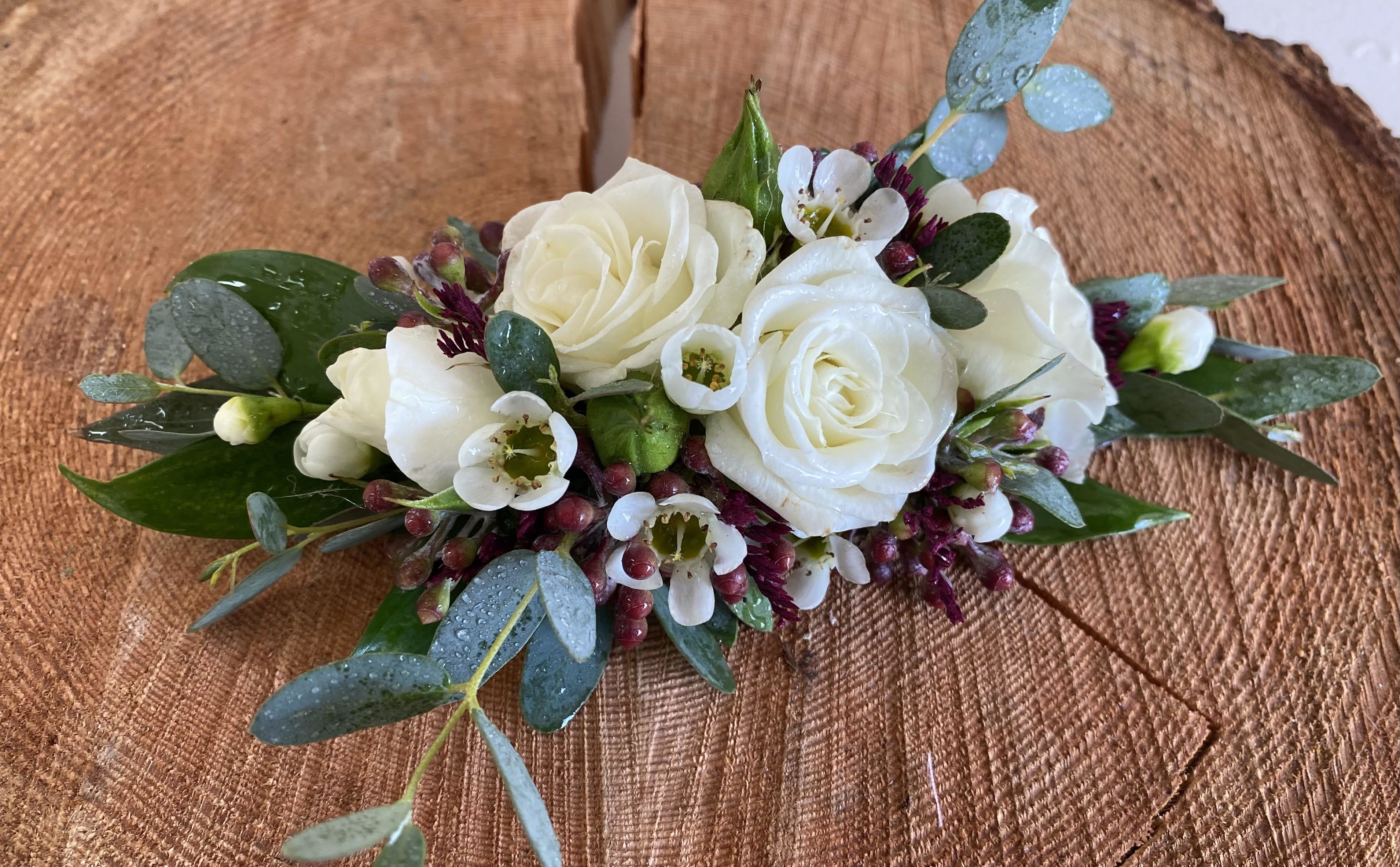 White rose bouquet with small white blossoms and eucalyptus