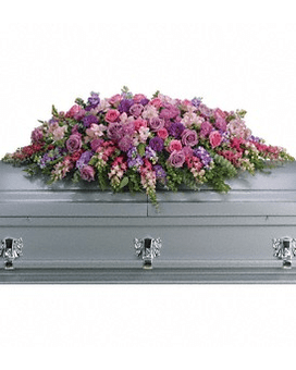 Lavender Tribute Casket Spray - Like a heartfelt embrace this beautiful casket spray delivers comfort and love in an extraordinary way. A wonderful array of lavender and pink flowers with just the right amount of greenery is a lovely way to pay tribute to someone who will always be with you in heart mind and spirit. Lovely lavender and pink roses snapdragons alstroemeria chrysanthemums fern eucalyptus and more create this tribute that is overflowing with grace and love. Approximately 51" W x 22" H   T235-2Aa