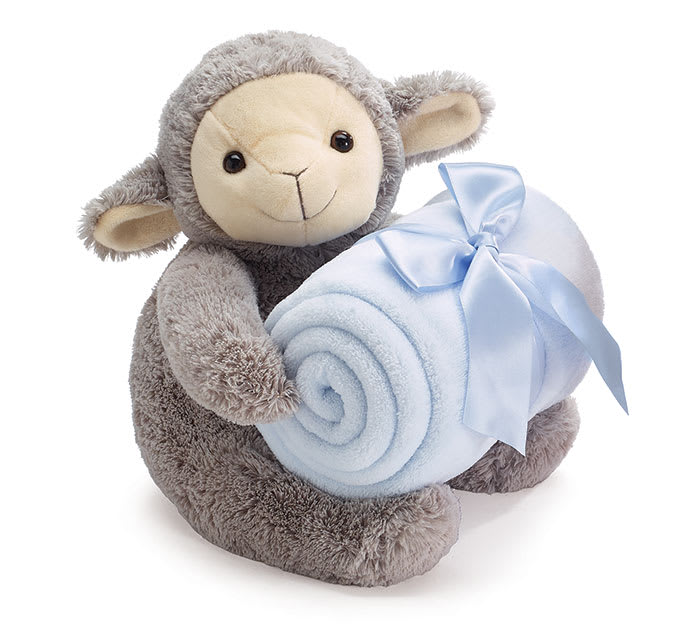 Plush lamb holding a rolled light blue blanket with a ribbon