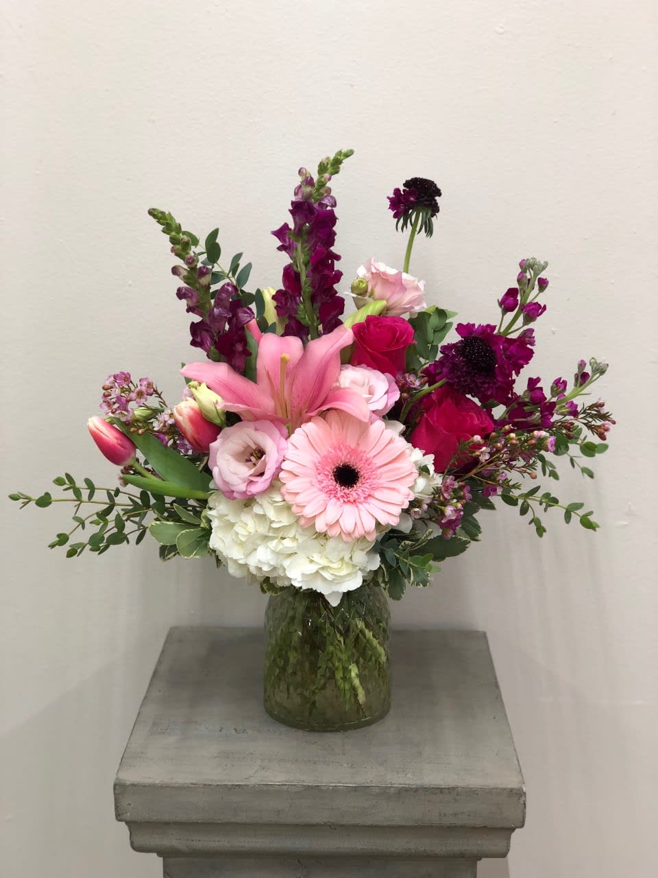 Pink and purple mixed bouquet in a glass vase