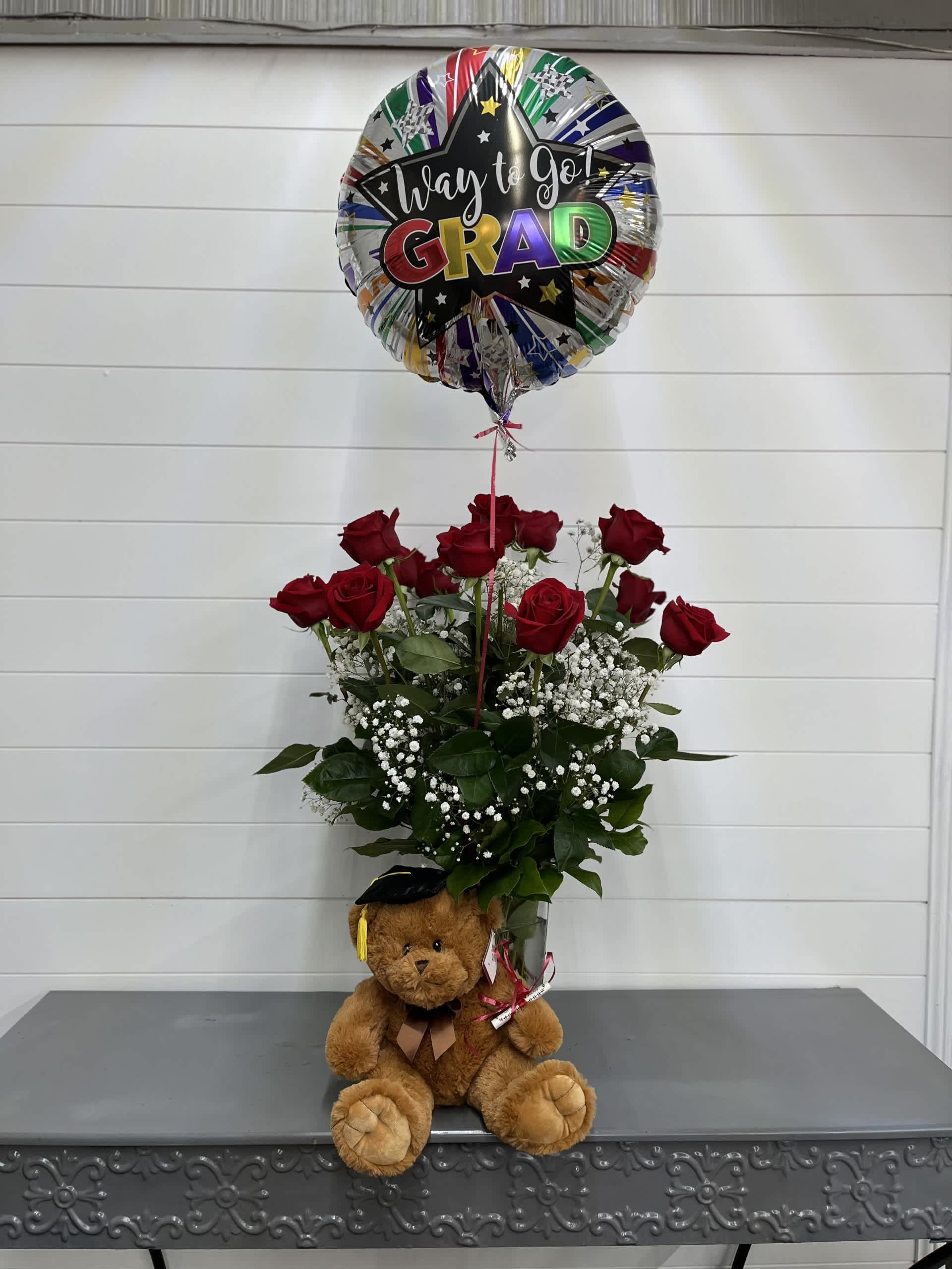 Red rose arrangement with a graduation balloon and teddy bear