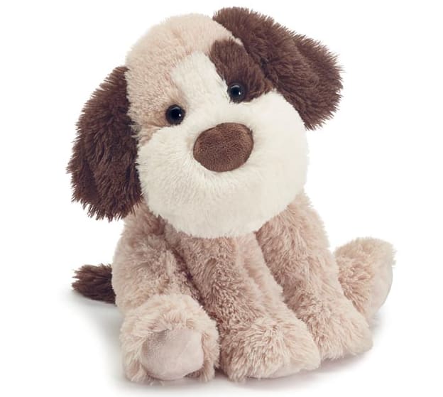 Plush brown and white stuffed dog sitting on a white background