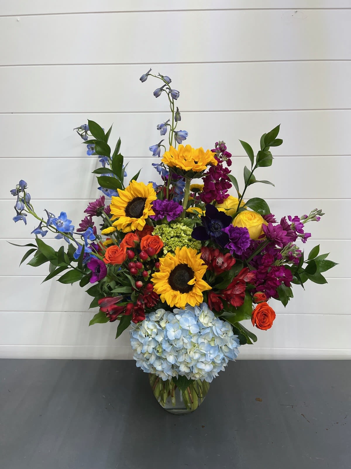 Colorful mixed flower arrangement in a clear glass vase
