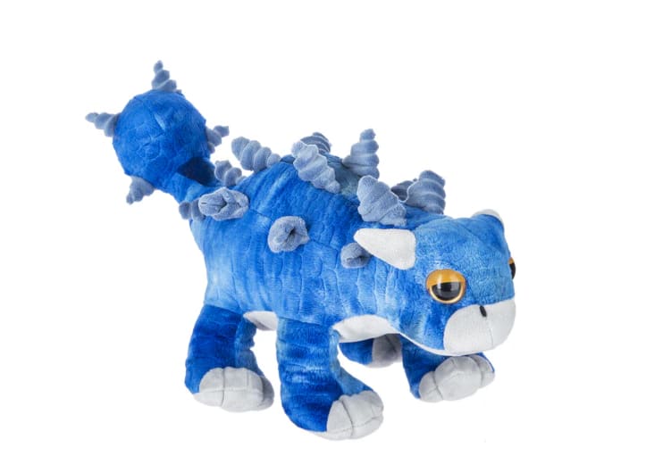 Blue plush dinosaur toy with gray spikes and white paws