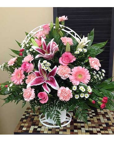 Pink and white mixed flower arrangement in a white vase