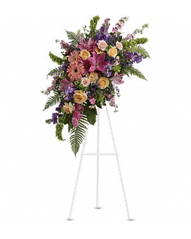 Standing floral spray with pink, purple, and yellow flowers on an easel