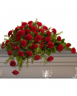 Red carnation spray on a gray casket