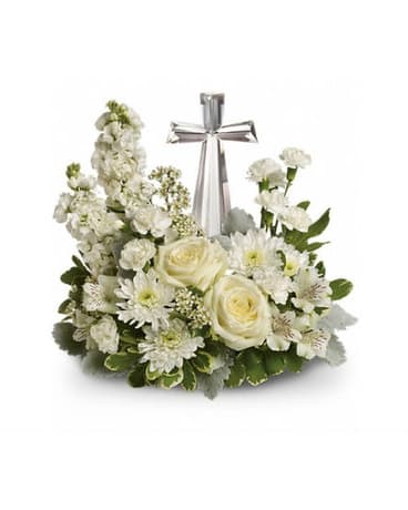 White floral arrangement with a silver cross centerpiece