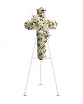 White floral cross on a stand with pale pink accents