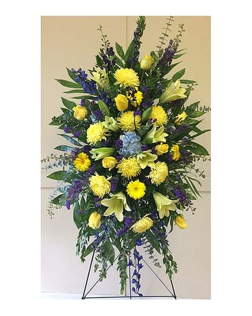 Tall standing floral spray with yellow and purple flowers