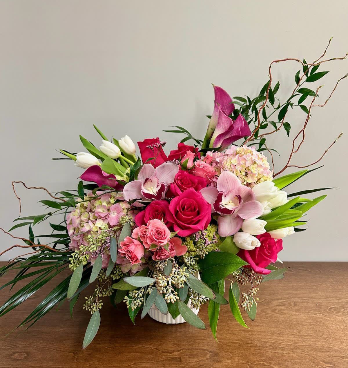 Pink and white floral arrangement in a white vase