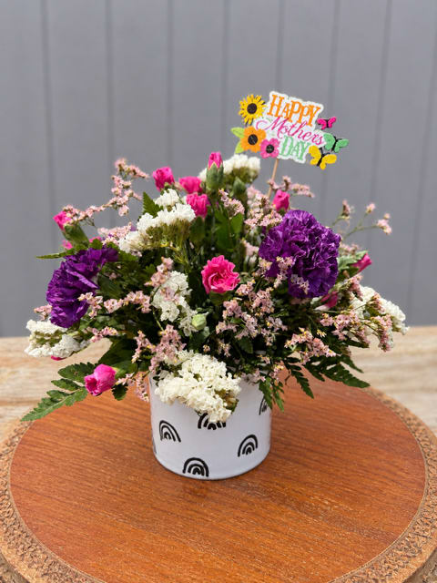 P.S. Celebrate Life - P.S. Celebrate Life  A joyful reminder to celebrate the beauty of life and the women who make it so meaningful.  Designed in our P.S. Celebrate Life planter, this arrangement features a fresh mix of pink and purple blooms, creating a soft, uplifting palette that feels both vibrant and heartfelt. Each design is thoughtfully arranged to bring color, warmth, and a sense of joy to any space.  This piece is perfect for Mother’s Day, offering a lasting sentiment that goes beyond the moment and serves as a daily reminder of love, appreciation, and celebration.
