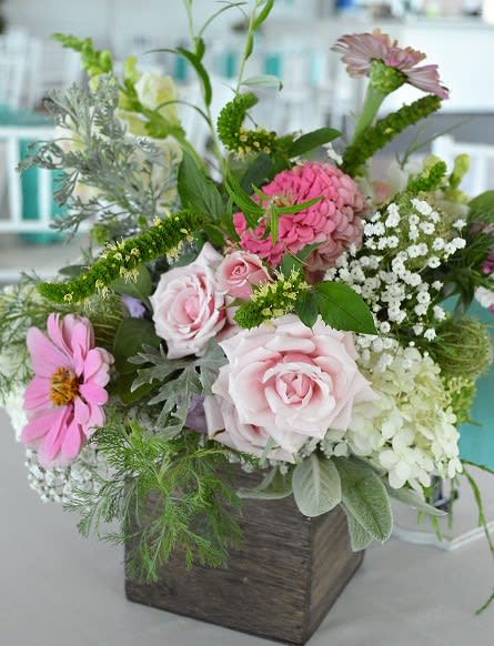 Mixed pink and white flowers in a square wooden container