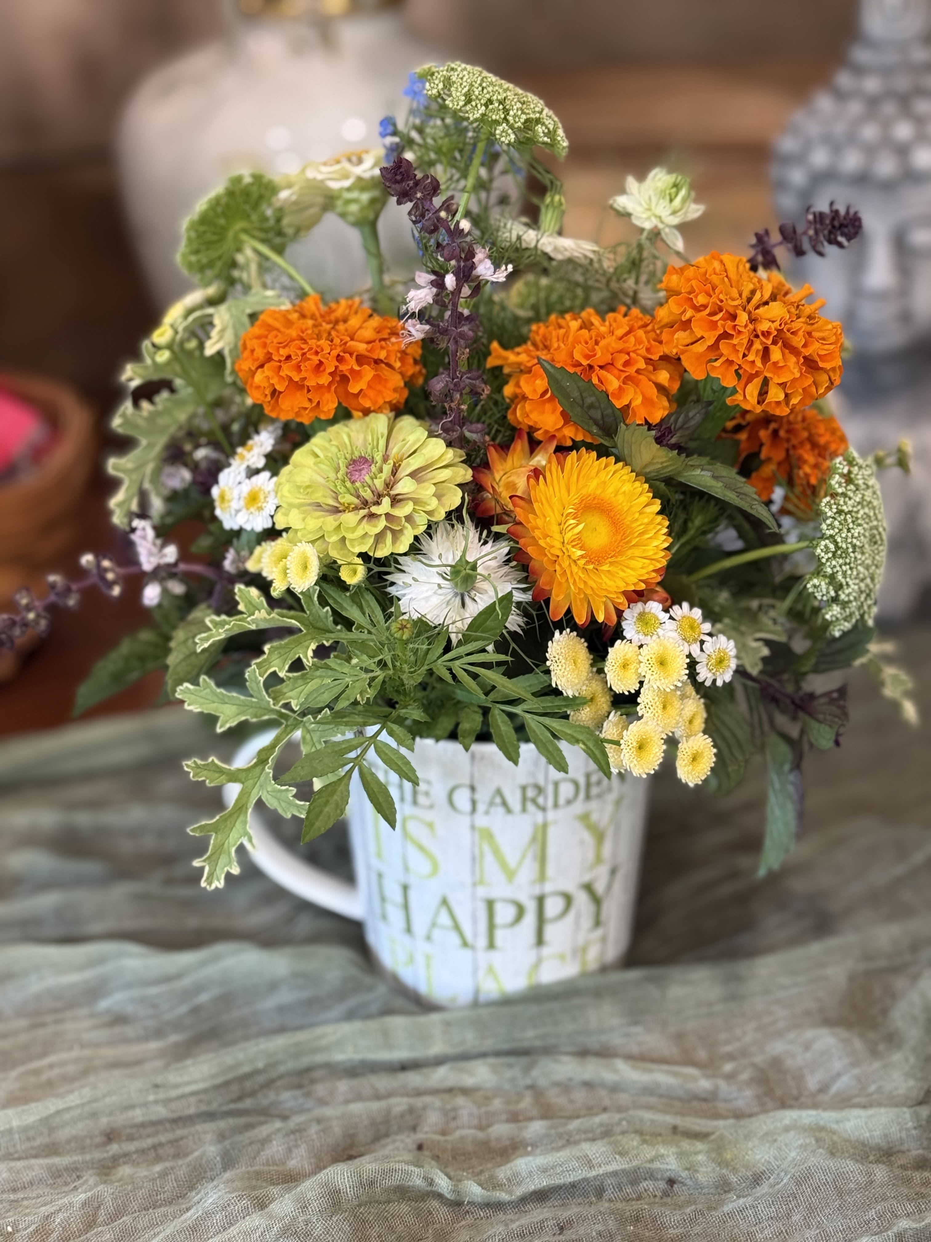 Garden Mug  - A lively, garden-style flower arrangement in a white ceramic mug brings an effortless burst of cheer-perfect as a birthday bouquet, a thank-you gift, or a "just because" surprise for someone you want to brighten. 