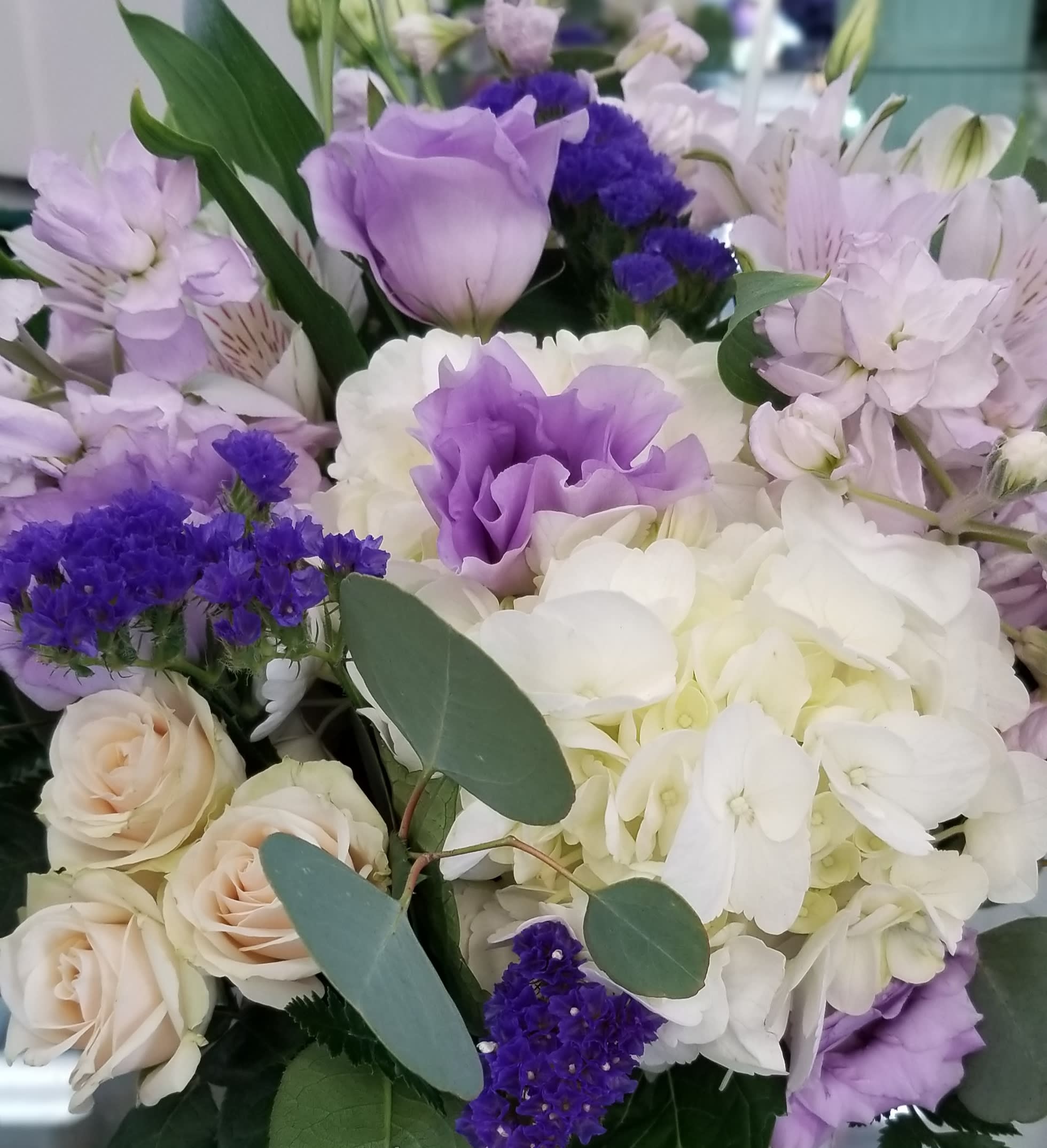 Lavender and white bouquet with roses, hydrangeas, and lilies