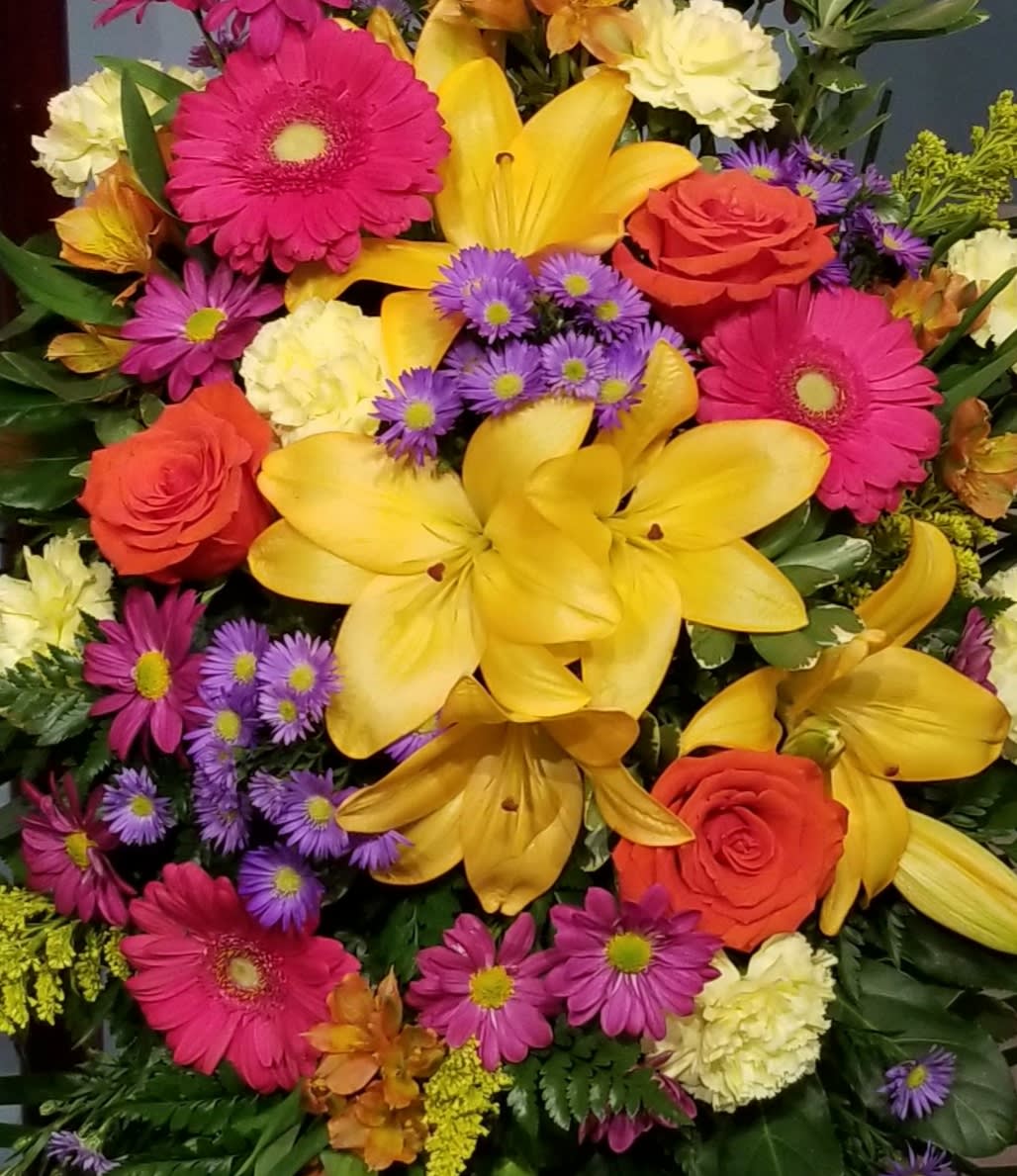 Bright mixed bouquet with yellow lilies, pink gerberas, and orange roses