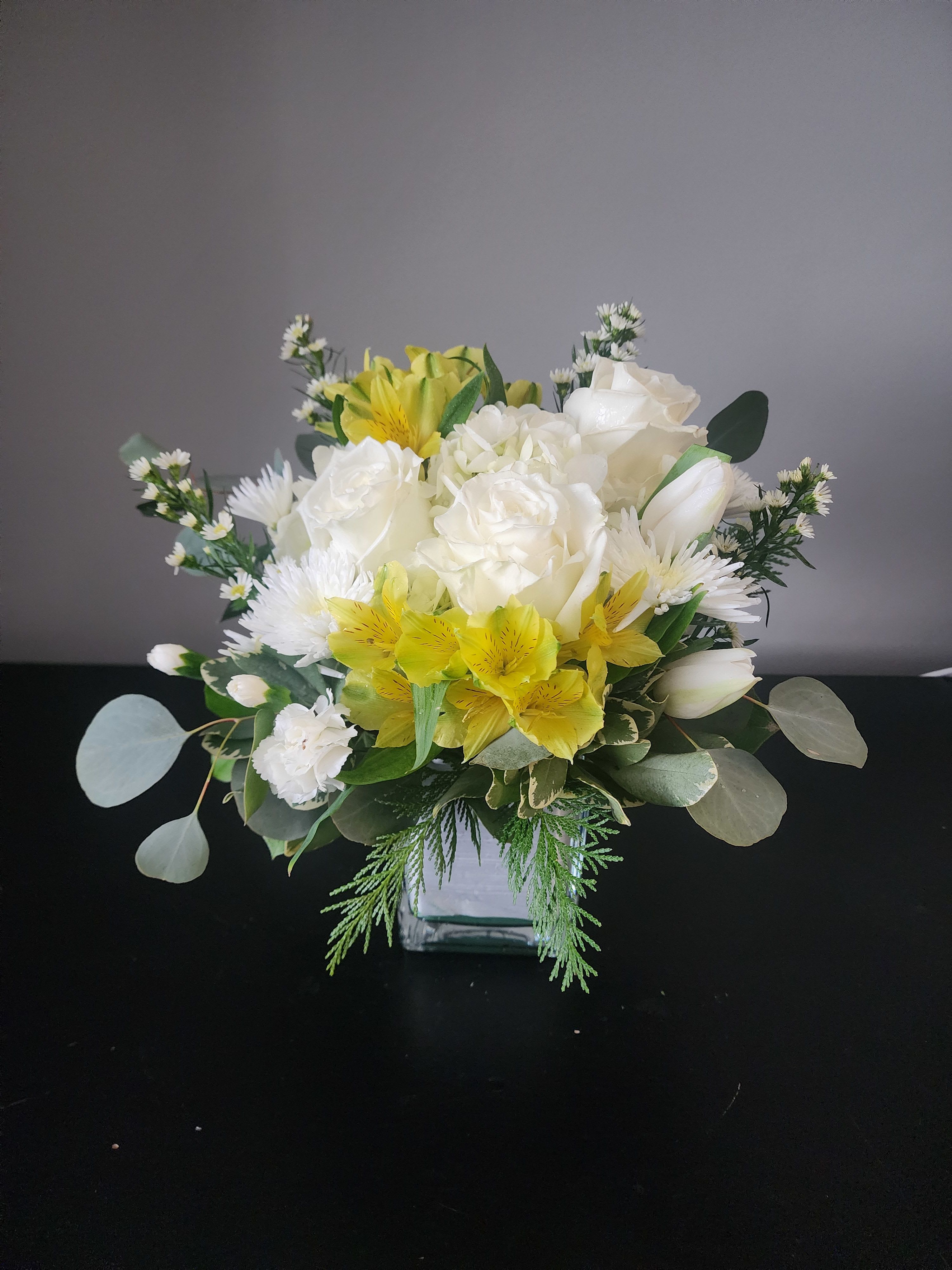 Joyful By MG Florist  - Designed in a glass cube with roses, alstroemeria, hydrangea, tulips, accent blooms, and a variety of greenery.
