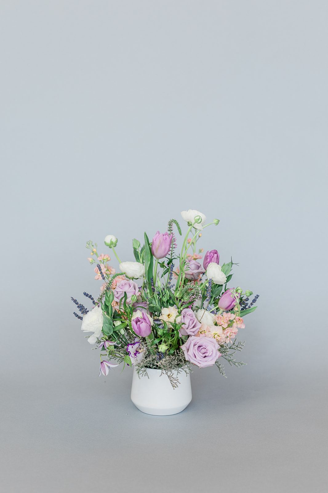 Lavender and white mixed bouquet in a white vase
