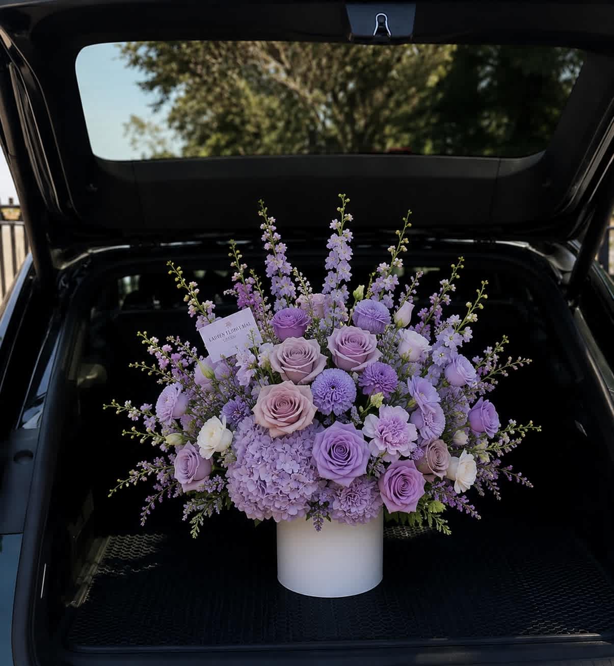 Lavender rose and hydrangea arrangement in a white vase