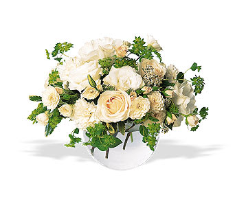 Cream roses arranged in a low clear glass vase