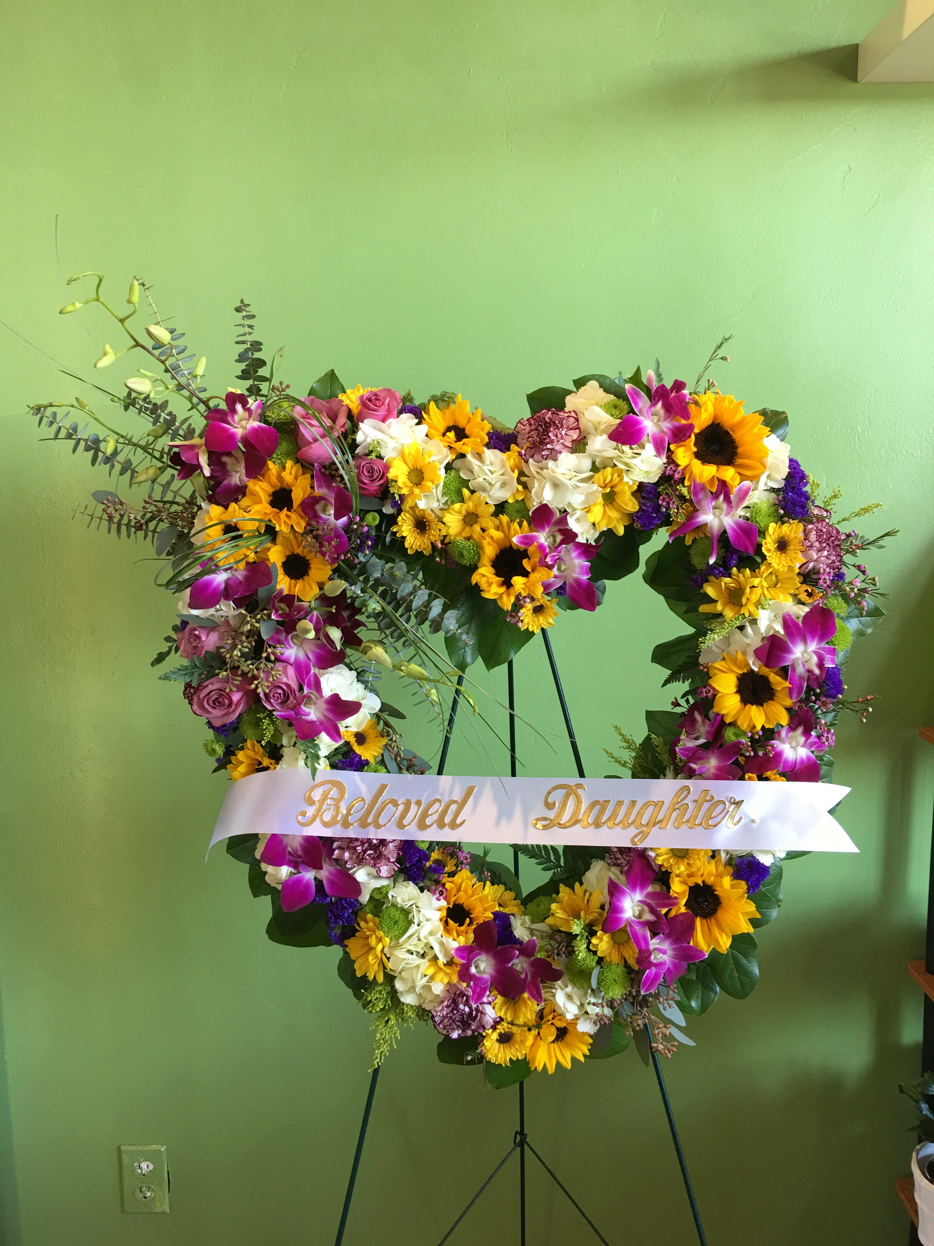 Heart-shaped floral wreath with a "Beloved Daughter" ribbon