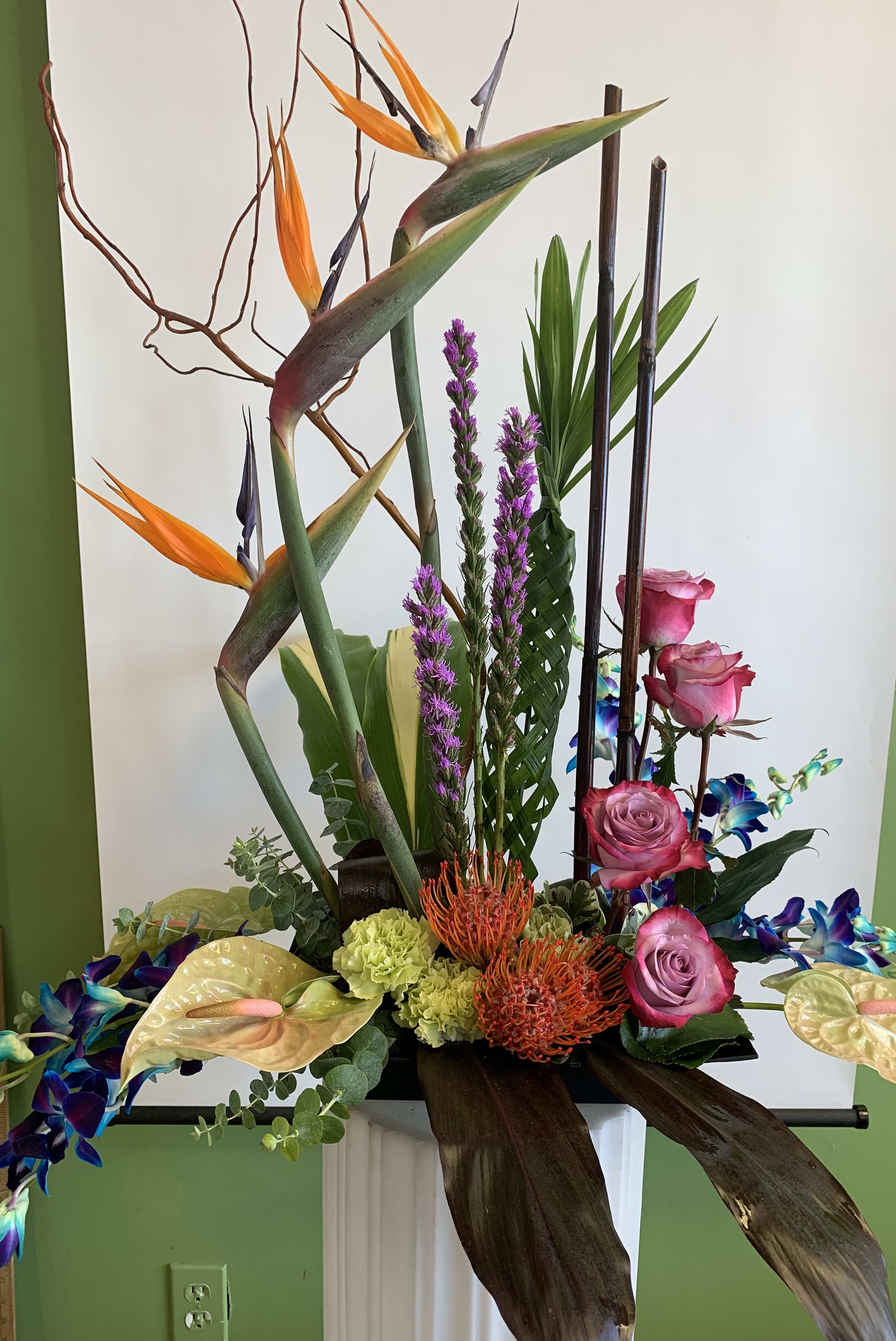 Tall tropical arrangement with pink roses and orange bird-of-paradise flowers