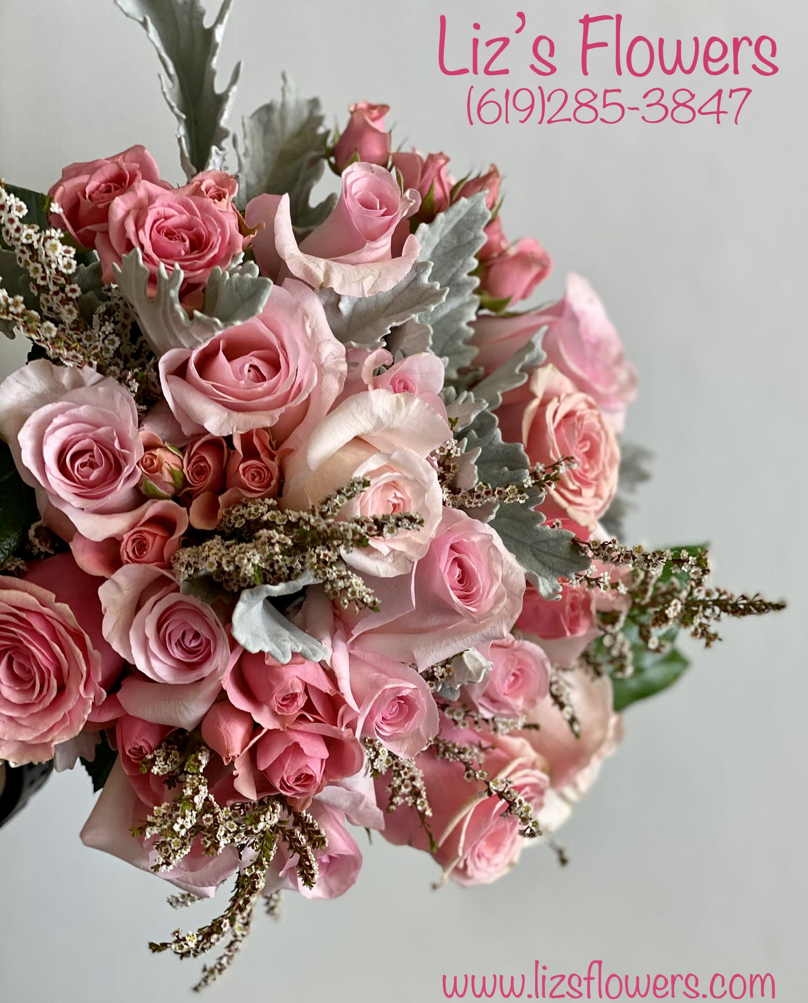 Pink rose bouquet with silver foliage and small filler flowers