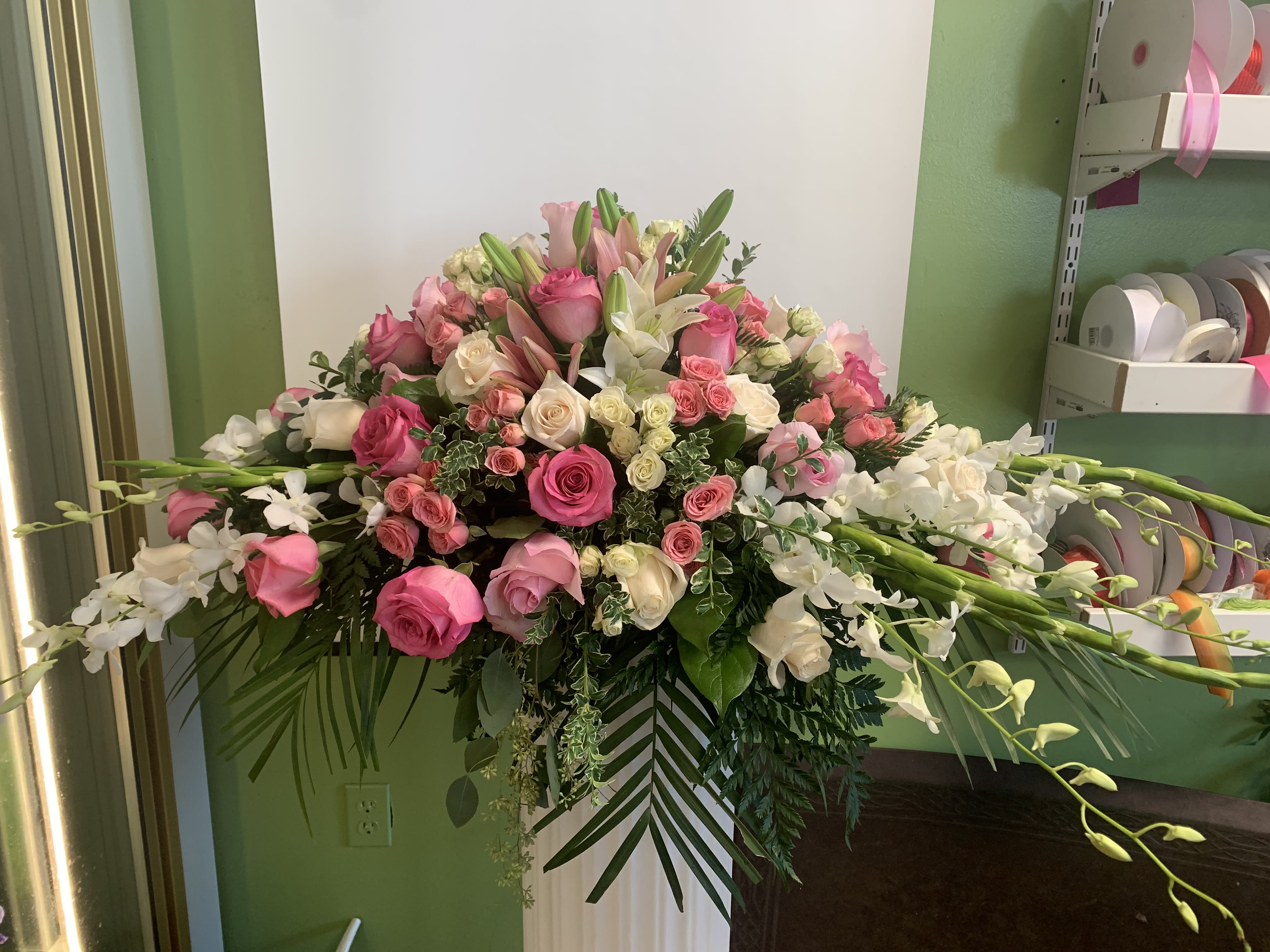 Large pink and white floral arrangement with roses and lilies