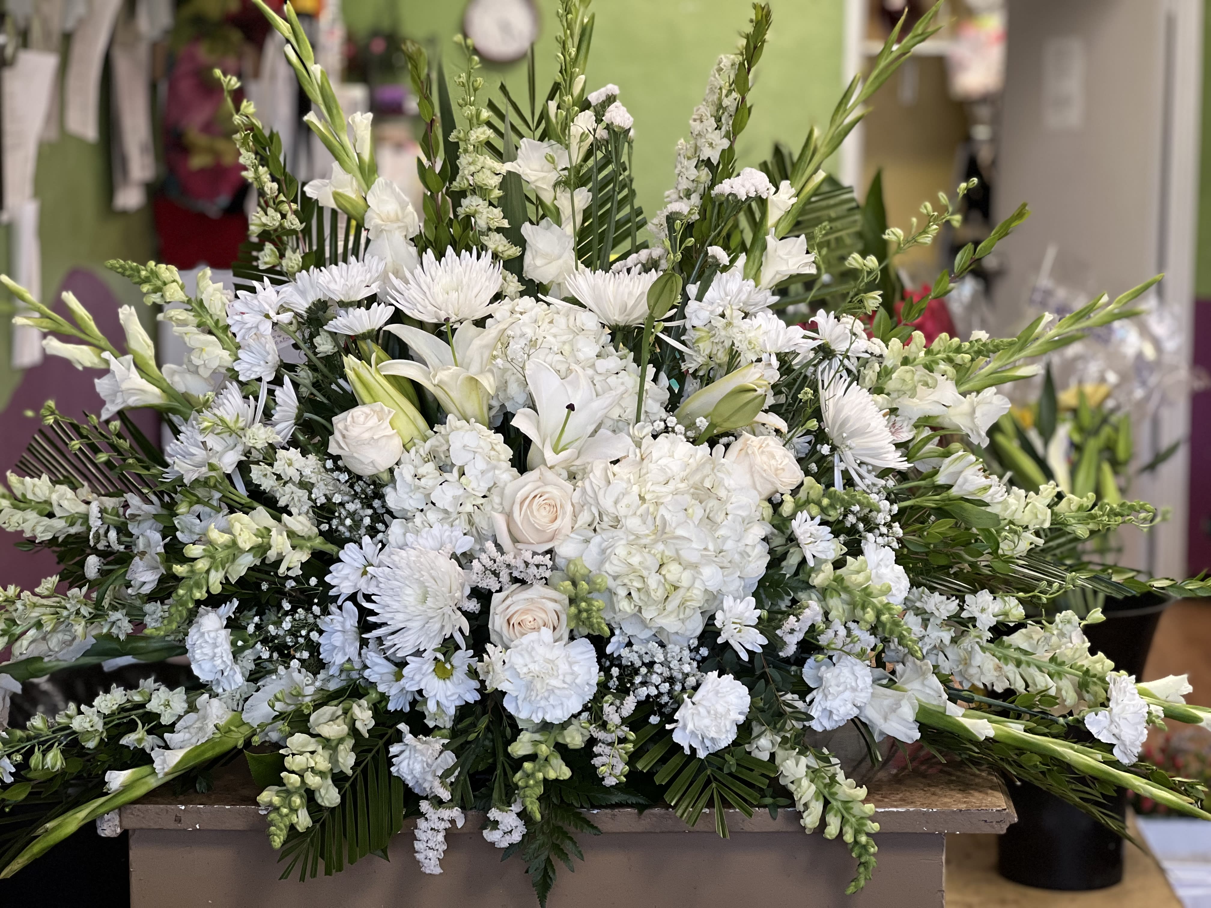 Large white floral spray with lilies, roses, and chrysanthemums